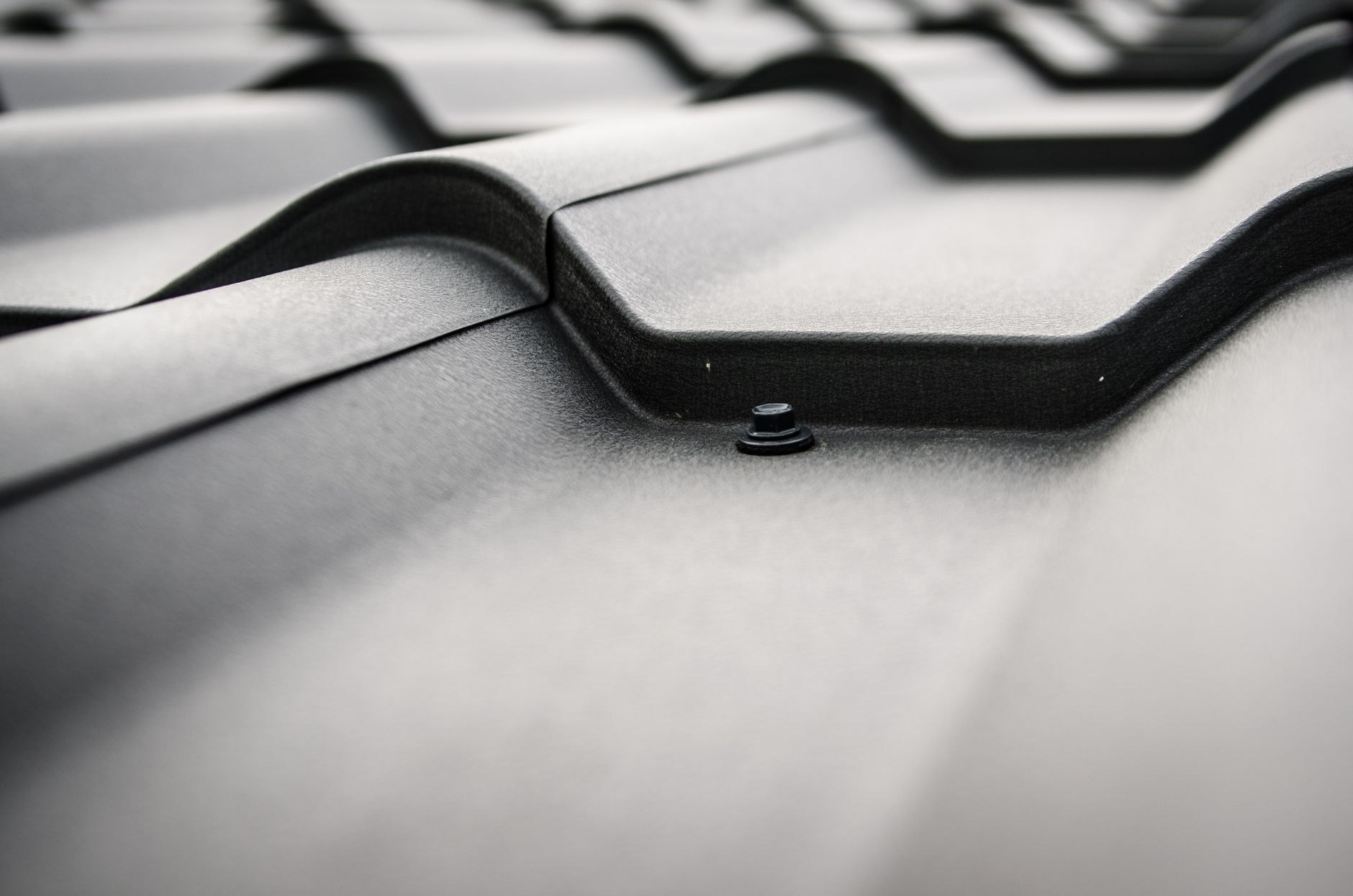 Close-up of dark corrugated metal roofing sheets