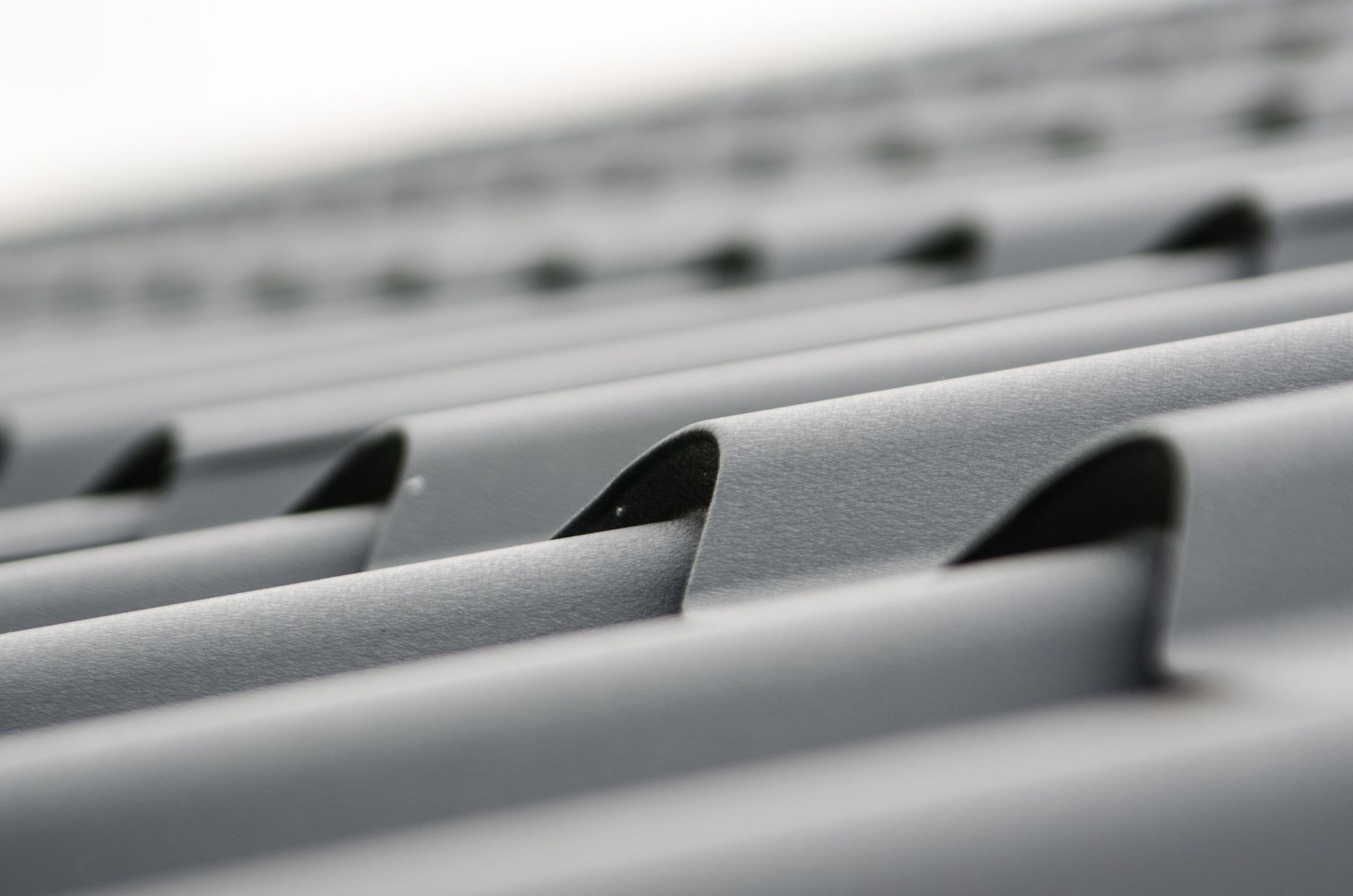 Grey corrugated metal roofing profile close-up